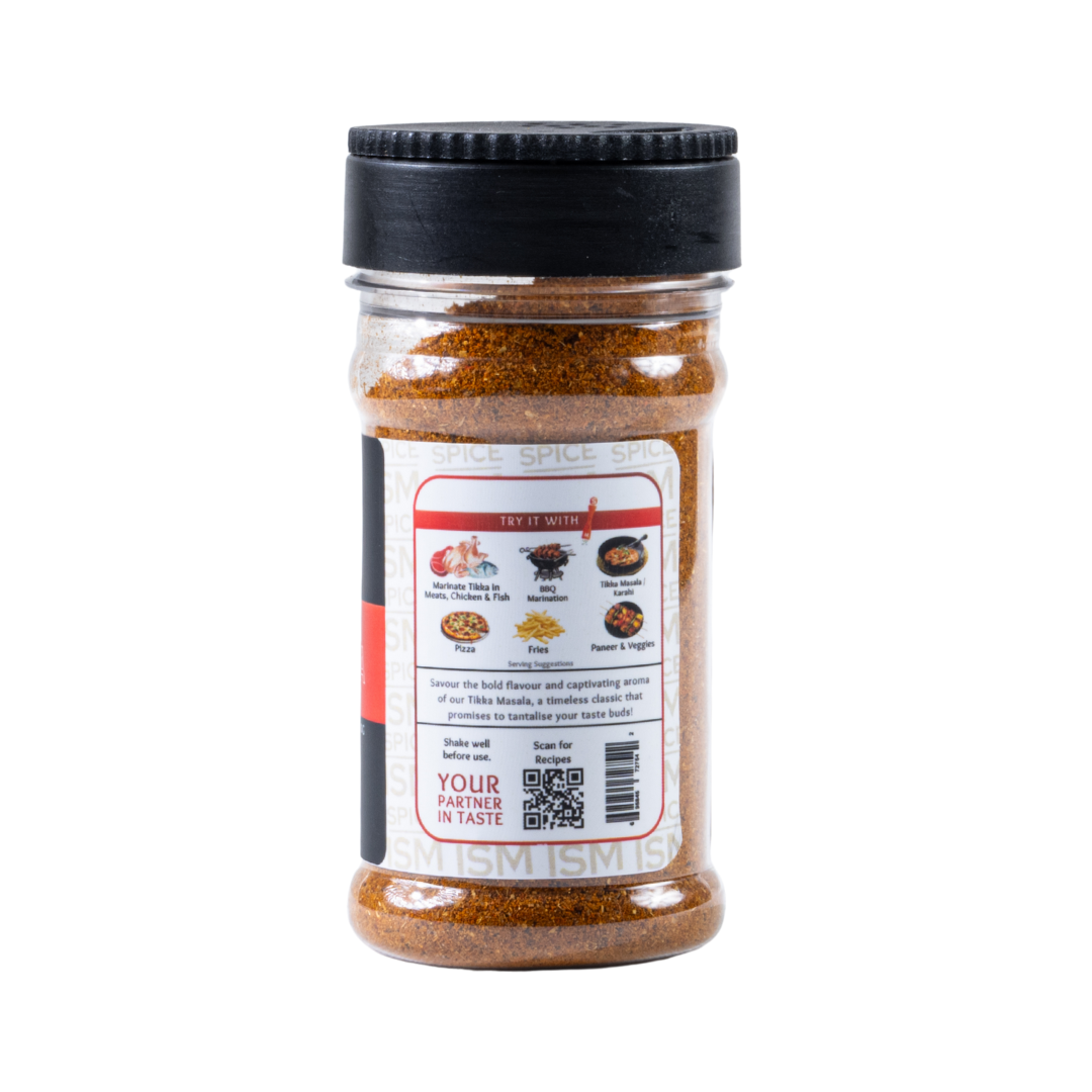 Sprinkling Tikka Masala Spice Blend on marinated chicken skewers – authentic desi spice mix