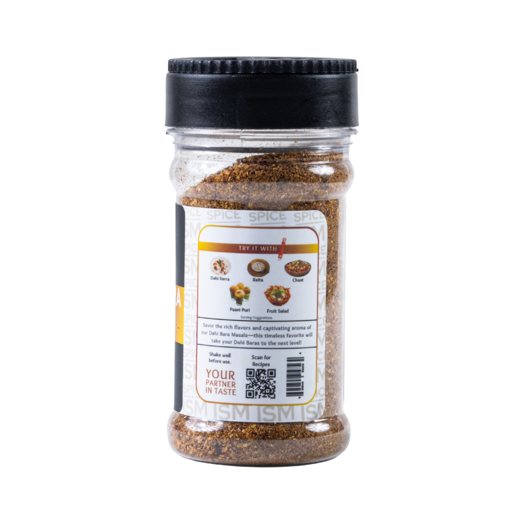 Sprinkling Dahi Bara Masala on yogurt dumplings – desi street food spice mix